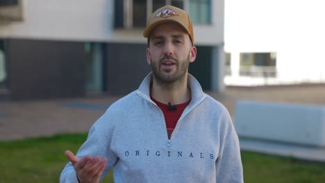 close-up eye-level shot of a presenter talking to the camera and explaining while wearing a lavalier microphone