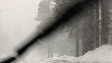 driving through a dangerous winter snow storm in the sierra nevada mountains