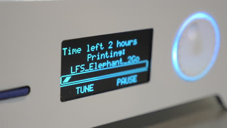 close-up of display 3d printer while working with progress bar