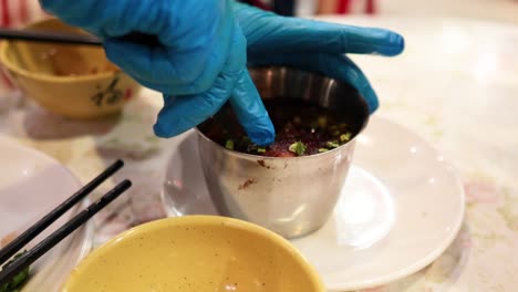 chef handling dongpo pork with precision and care