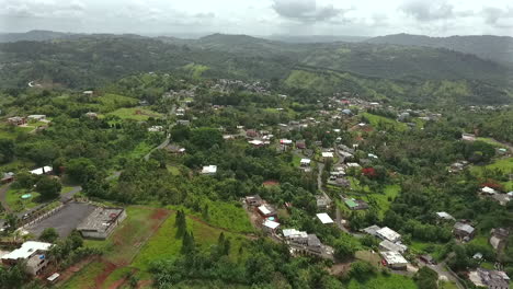 flying drone above the houses and trees in community the "corujas