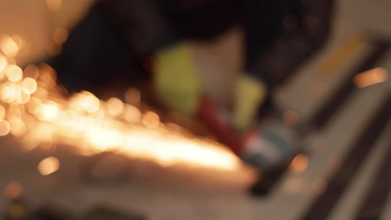 Blurred shot of a angle hand saw grinder with sparks erupting, closeup