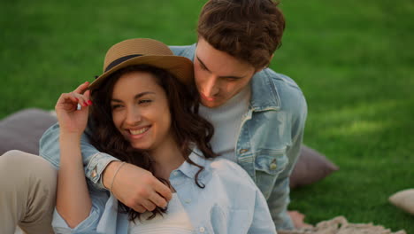 Positive-girl-and-guy-having-conversation-in-park.-Couple-lying-on-ground