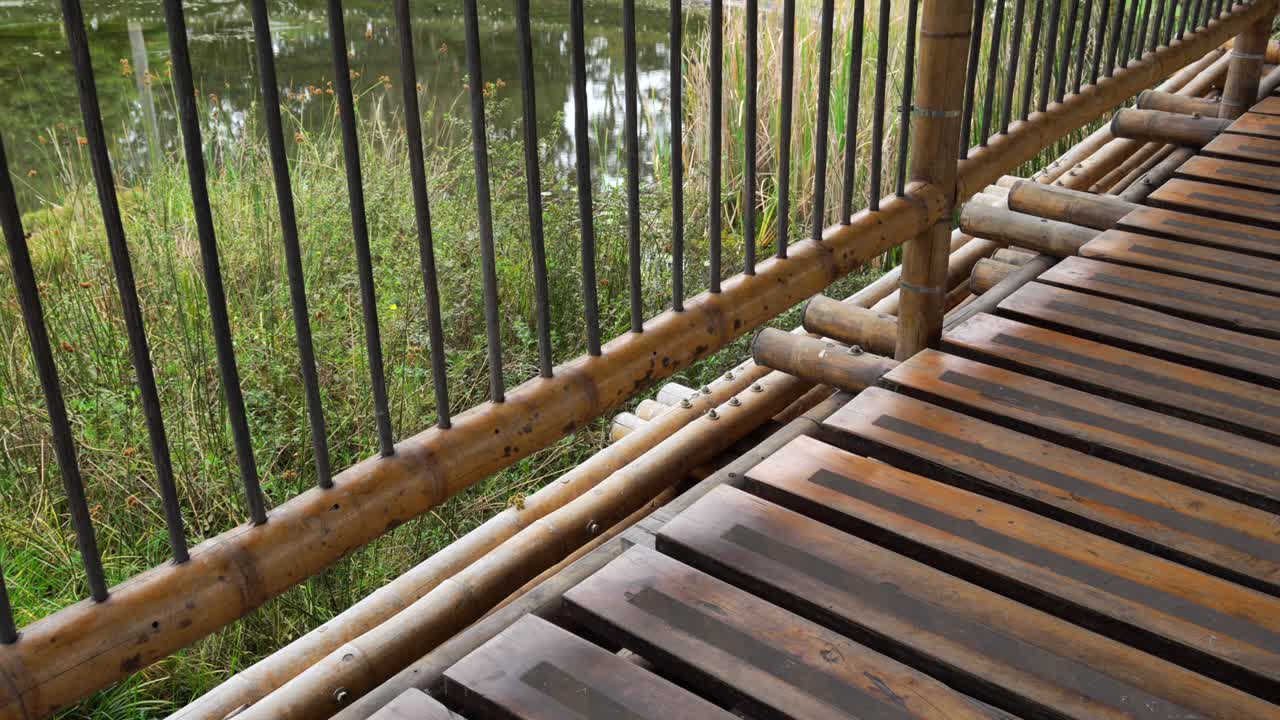 Bamboo wood bridge over swamp pond lake water inside Botanical Garden Bogota Colombia