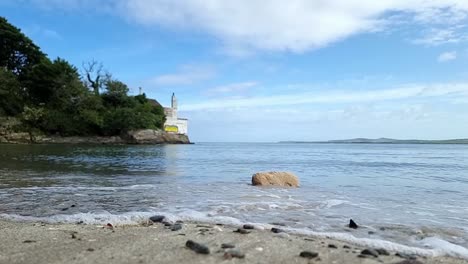 gorsedd y penrhyn hidden welsh beach with slow motion turquoise waves crash over coastal rock