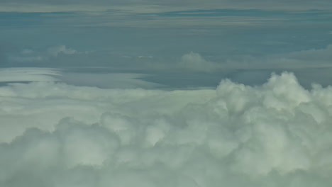 Panoramic-Window-Seat-Airplane-Flying-Top-View-Above-White-Clouds,-Blue-Skyline