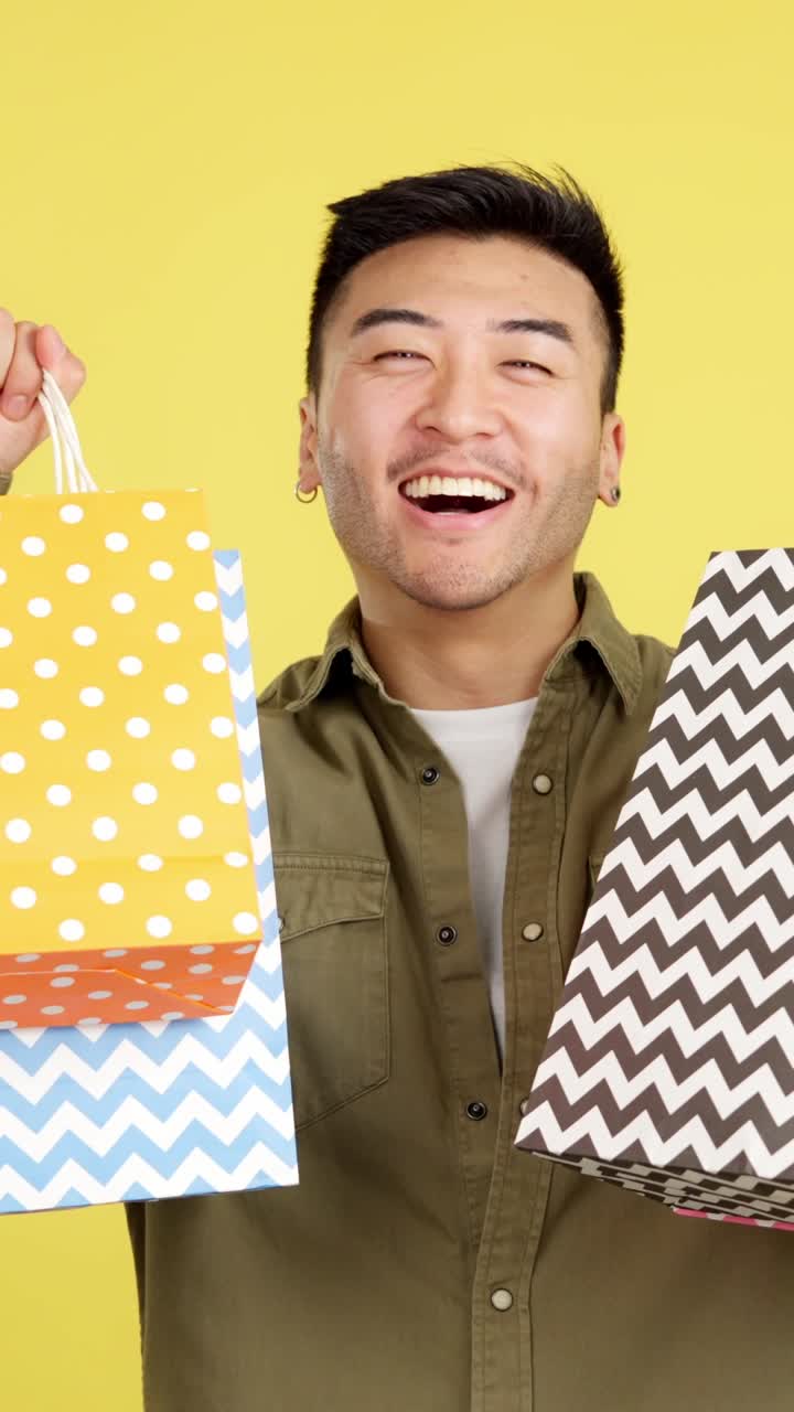 Man holding colorful shopping bags with patterns