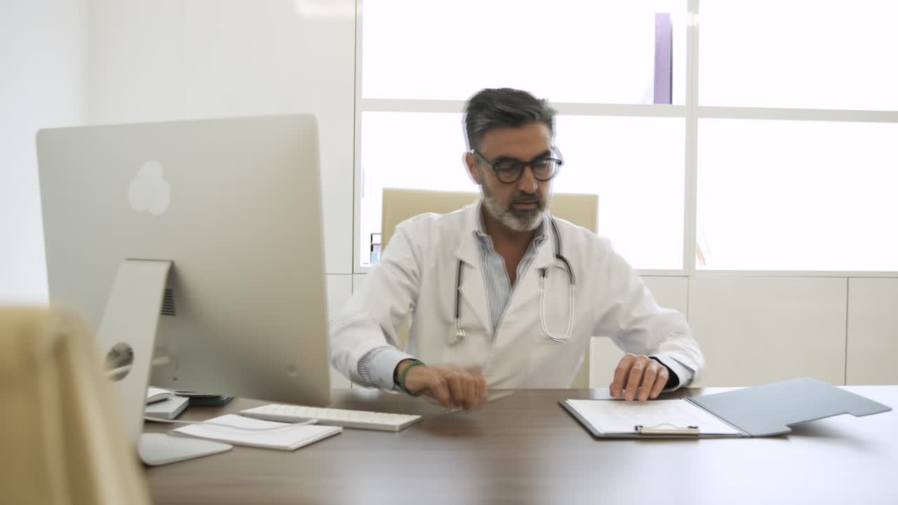 Serious male doctor working in office