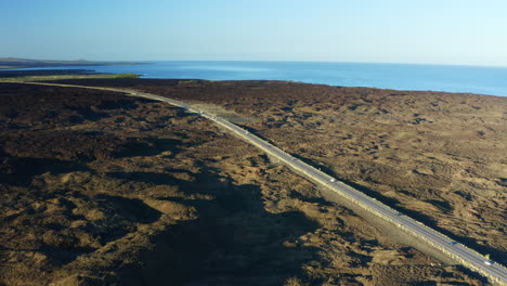 aerial drone over king kamehameha highway, coastal road across hawaii big island, 4k