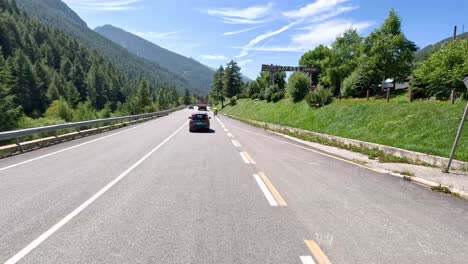 cars driving through scenic mountain road