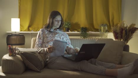 male student trying to finish her homework at night.