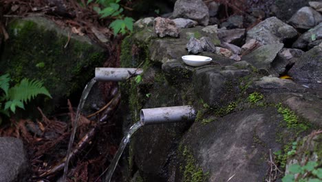 Fresh-Spring-Water-Flowing-Out-Through-The-Pipes-On-A-Mountain---close-up