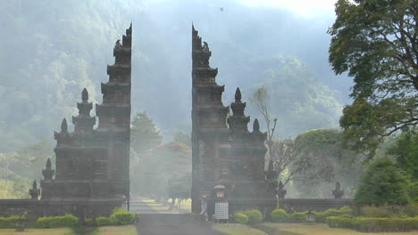 the fog drifts by a traditional balinese temple gate in bali indonesia