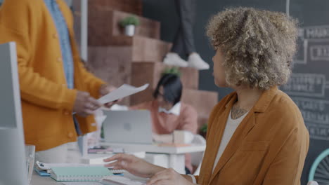 business colleagues reviewing documents in modern office