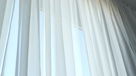 white sheer curtains by a window