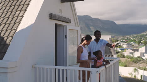 diverse family enjoying scenic mountain view from balcony during vacation, relaxed, copy space