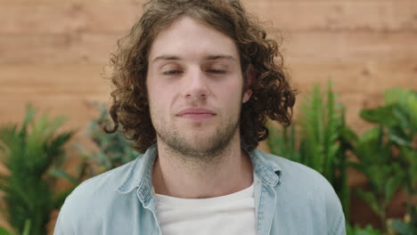 handsome young guy portrait of pensive caucasian man looking confident at camera relaxed