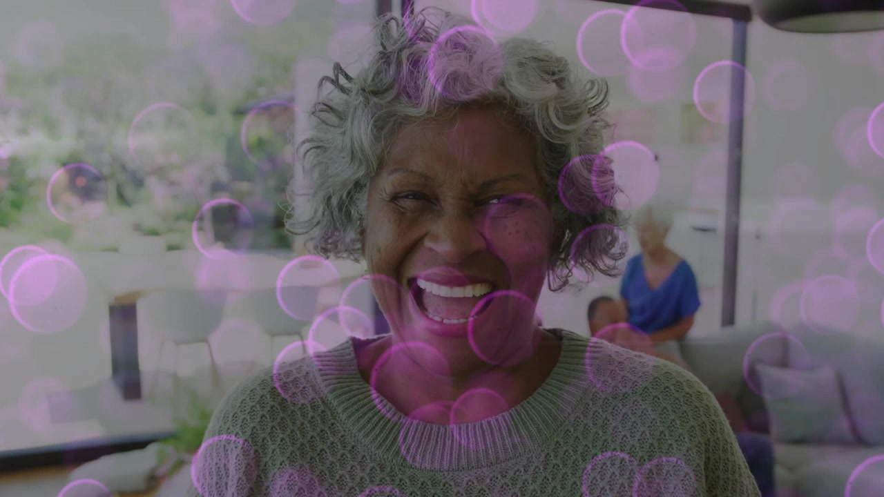 After clip start grandma laughing with mom holding baby, starting pink bubble overlay for lifestyle