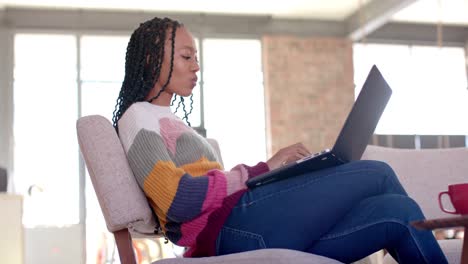 African-american-casual-businesswoman-using-laptop-in-office