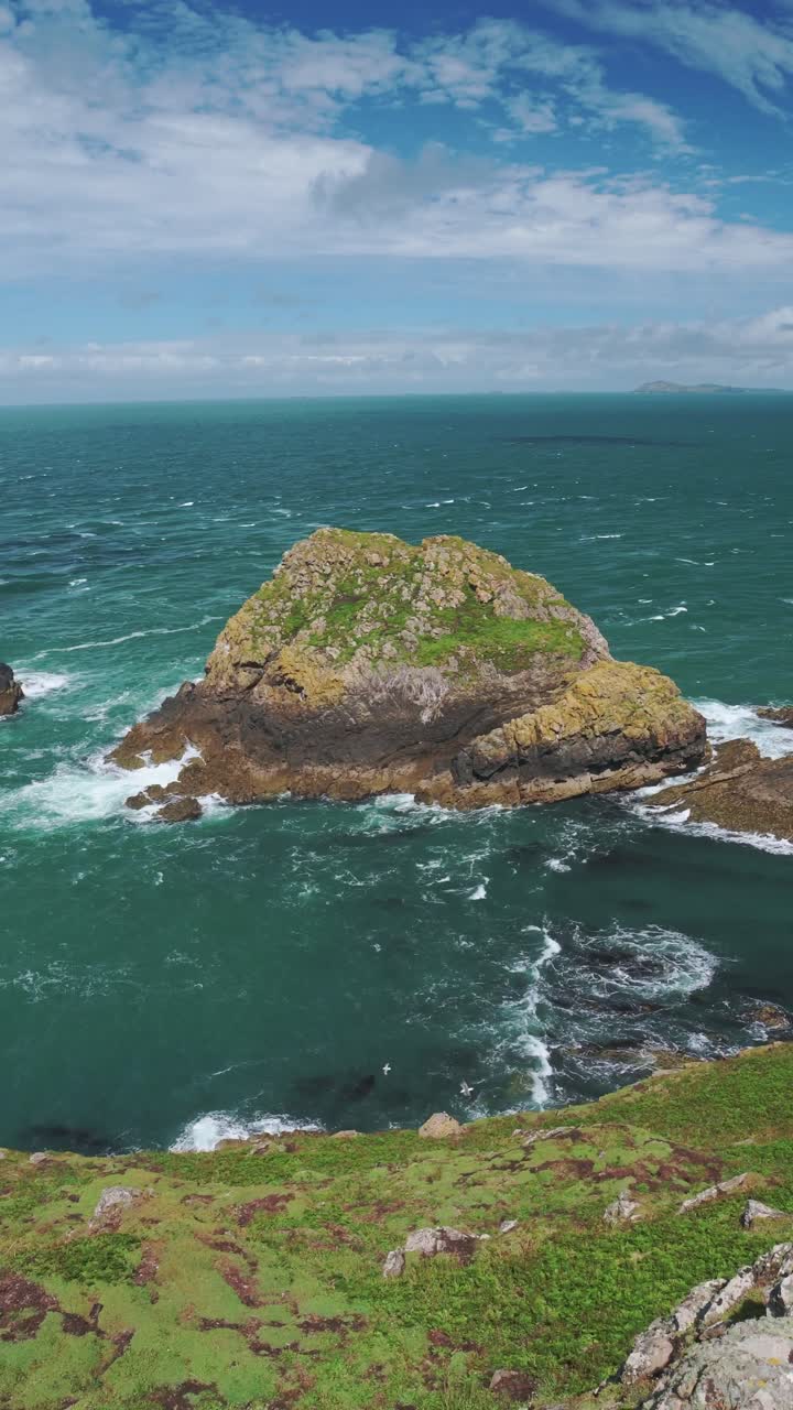 UK Coastal Landscape Scenery with Beautiful Blue Turquoise Water and Rocky Coastline on Skomer Island in Wales on Blue Sky Sunny Day