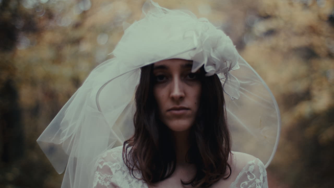 Portrait of a bride in a wedding dress and veil, expressing melancholy or contemplation