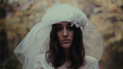 portrait of a bride in a wedding dress and veil, expressing melancholy or contemplation