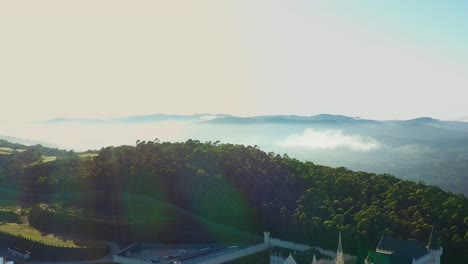 Sunrise-over-gothic-style-religious-building-situated-on-top-of-mountain