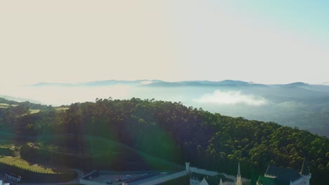 sunrise over gothic style religious building situated on top of mountain