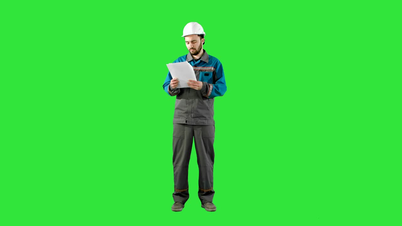 Engineer Man Verify and Read Files Documents on a Green Screen, Chroma ...