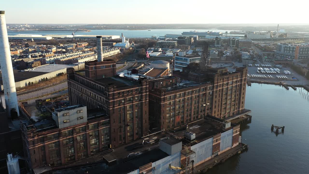 Aerial View of Baltimore City Harbor and Business Area Under Golden Hour Sunlight, Maryland USA