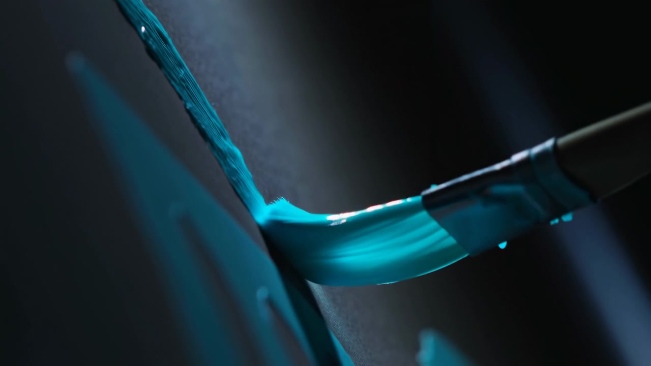 Extreme close-up of paintbrush tip applying glossy teal paint on vertical matte substrate, showing wet residue, tiny droplets, reflective ferrule, saturated bristles, and subtle color transition