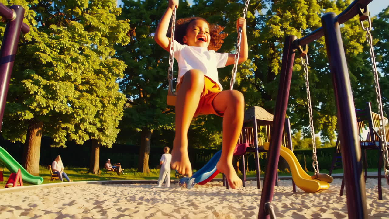 Happy Child Swinging at Playground