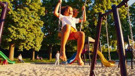 happy child swinging at playground