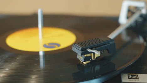 stationary shot of a vintage vinyl record spinning on a turntable