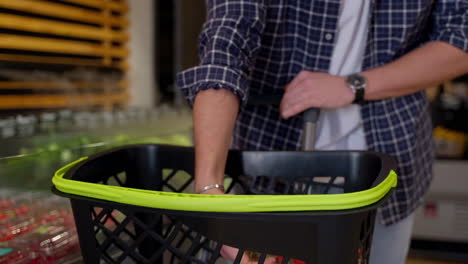 person buying strawberries in a grocery store