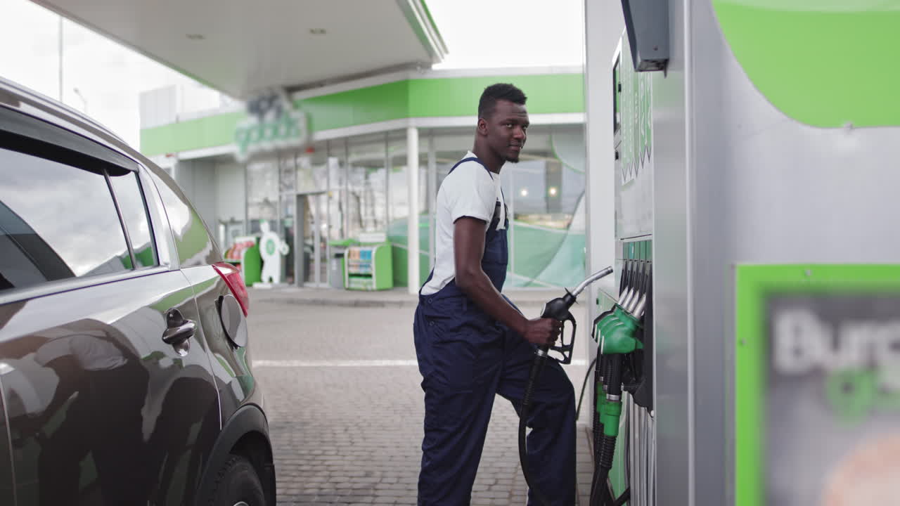 Man refueling a car at a gas station