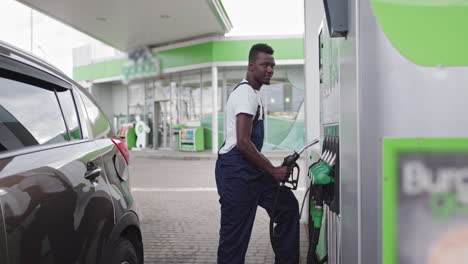 man refueling a car at a gas station