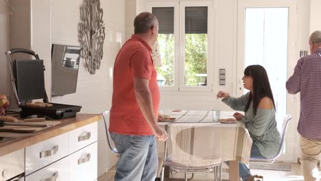 grandparents preparing breakfast for daughter and granddaughter