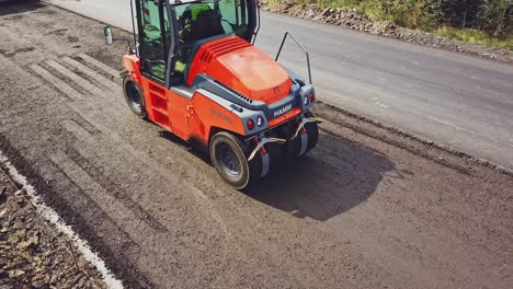 heavy asphalt roller that stack and press hot asphalt. road repair machine. repairing in modern city with vibration roller compactor. aerial view.