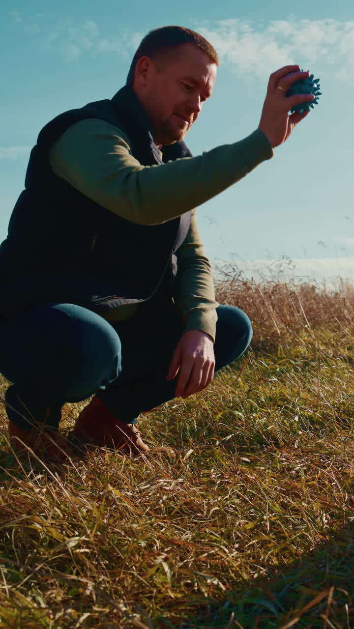 A man joyfully interacts with his dog in a sunny field, capturing the essence of companionship and joy as they share a playful moment, highlighting the bond between humans and their four-legged friends
