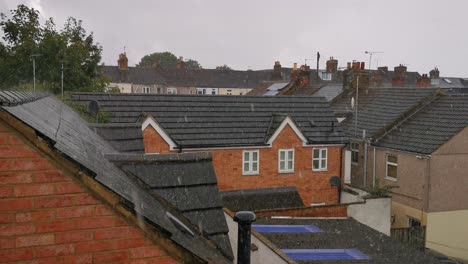 a heavy downpour of rain over some central swindon roof-tops