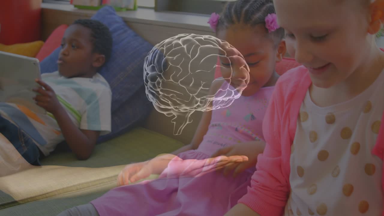 Two girls leaning in classroom while faint hand and brain graphic fading above, showing learning
