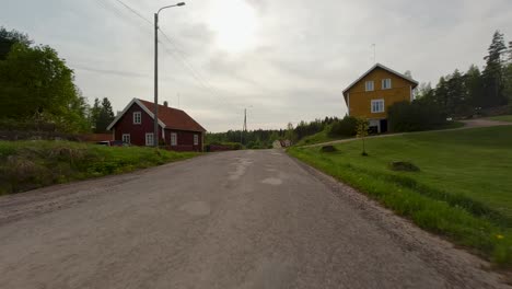 The-road-winds-its-way-through-the-countryside,-passing-by-quaint-villages-and-surrounded-by-the-serene-beauty-of-the-neighboring-forest