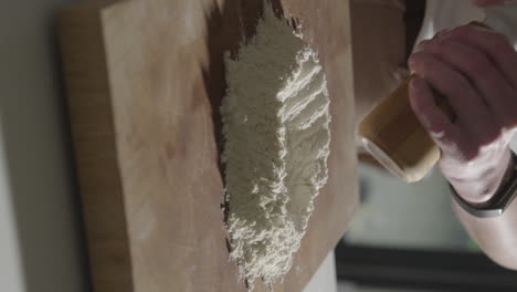 Adding-salt-to-flour-while-preparing-Italian-pasta-dough