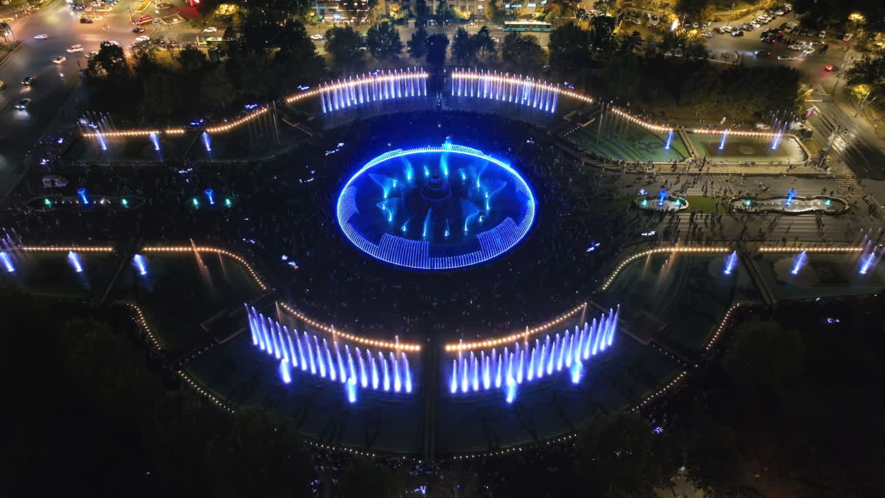 Aerial drone view of the illuminated Bucharest fountains in Romania, at night