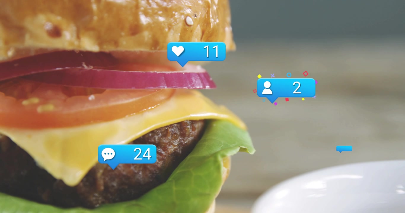 Reaction badges spawning above cup floating and clustering around burger, showing rising engagement
