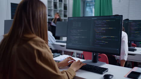 woman coding at a desk