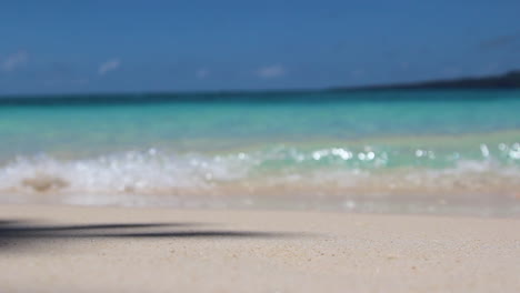 rack focus of waves lapping at a beach in boracay, philippines