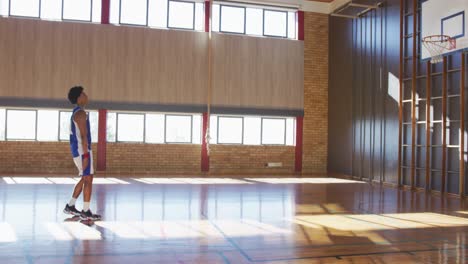 african american male basketball player practicing shooting with ball