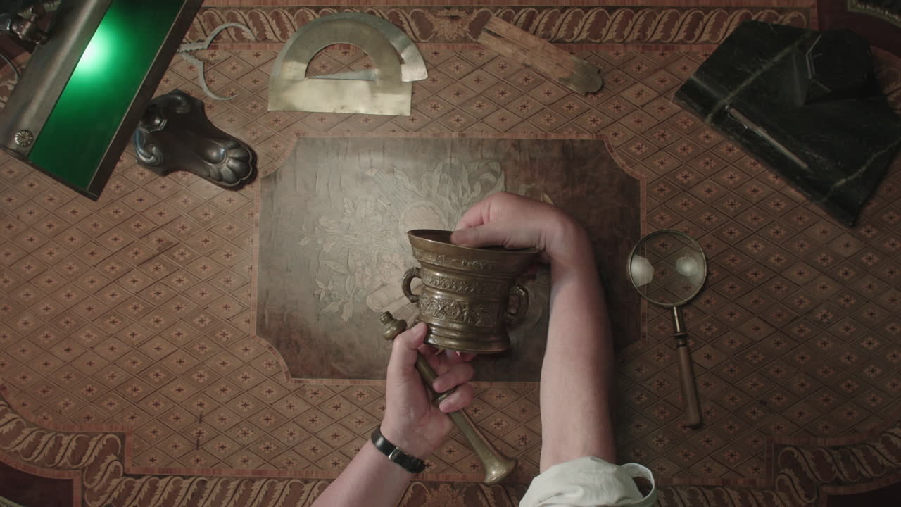 An older man evaluates an old mortar